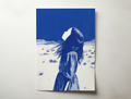 Elira minimalist portrait wall art showing a woman in a blue desert landscape looking toward the sky
