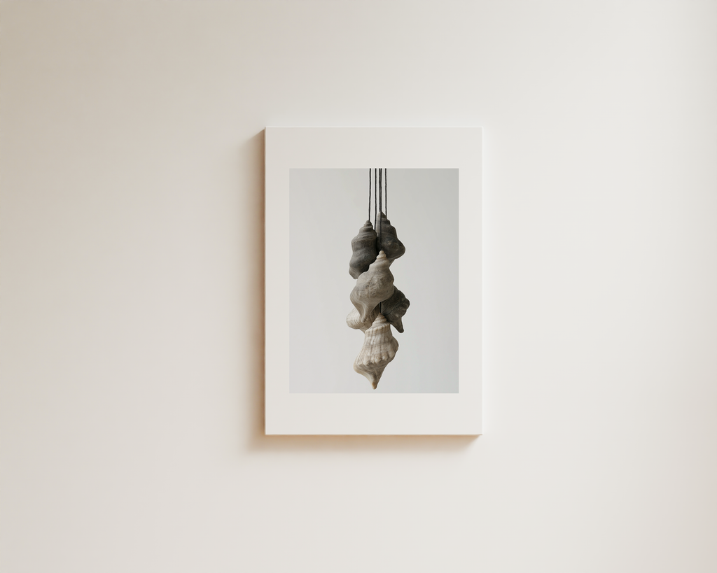 Minimal wall art with layered hanging sculptural forms