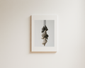 Minimal wall art with layered hanging sculptural forms