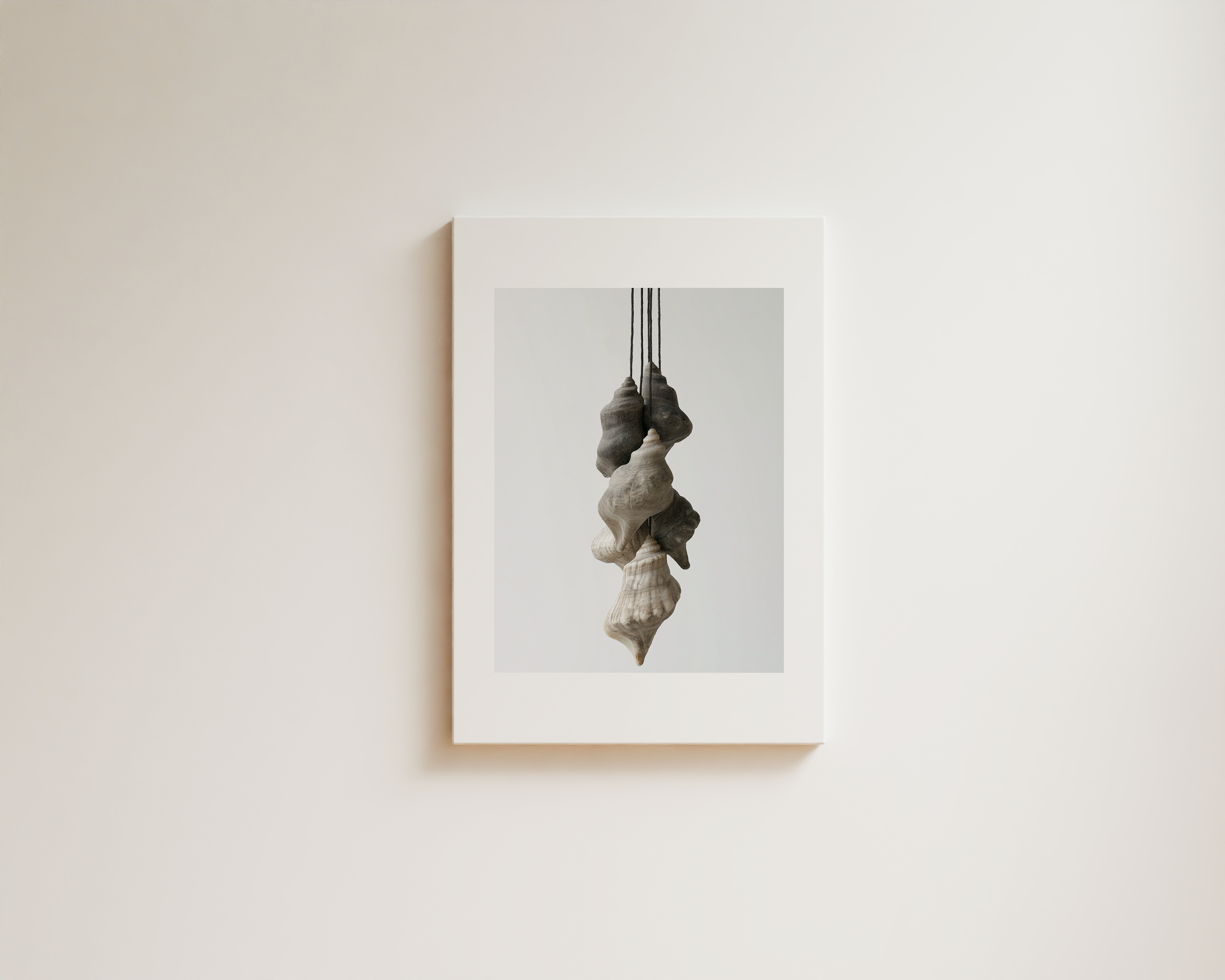 Minimal wall art with layered hanging sculptural forms