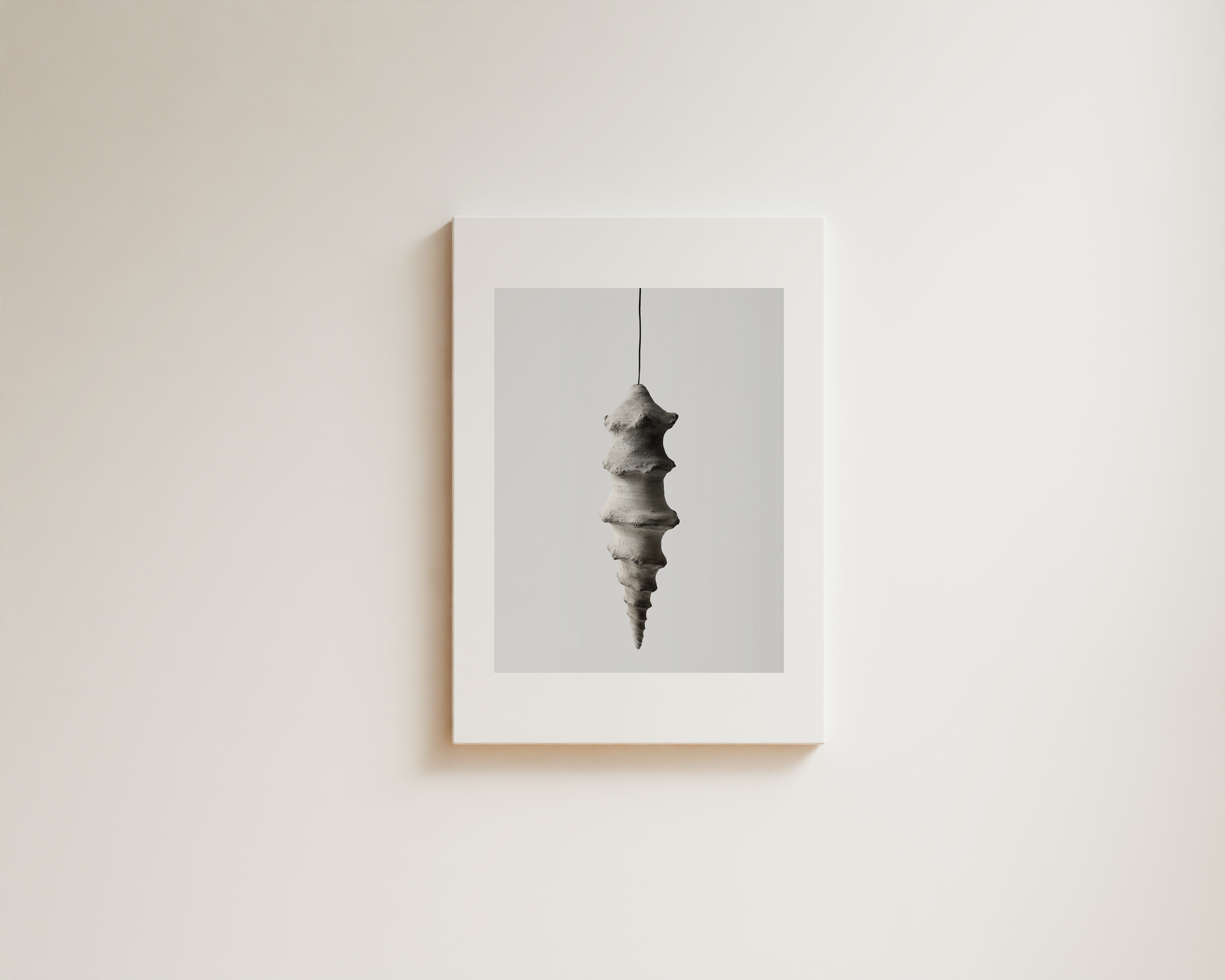Minimal neutral wall art with sculptural hanging form